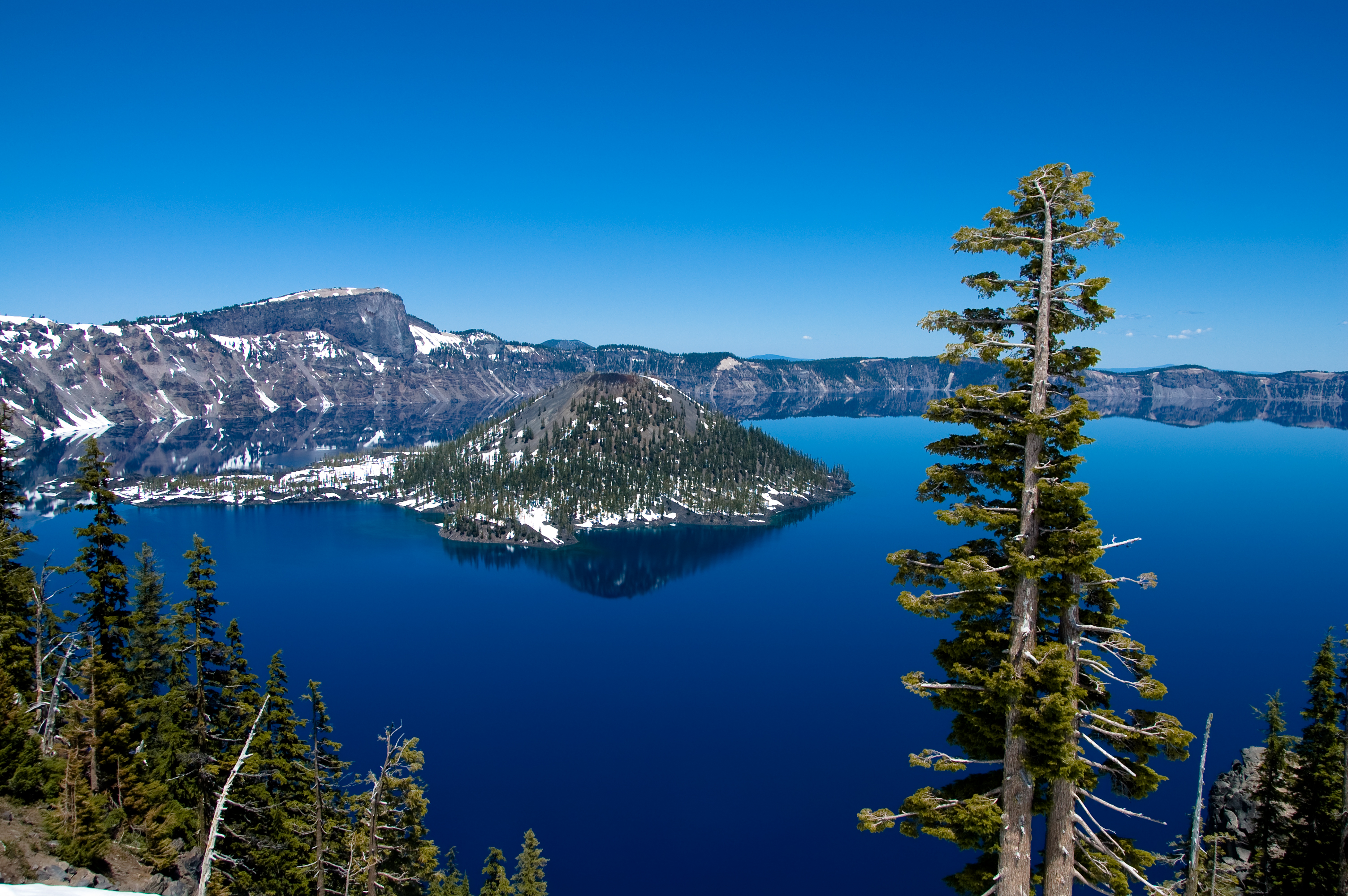 Aerial view of Crater Lake's deep blue water and caldera rim